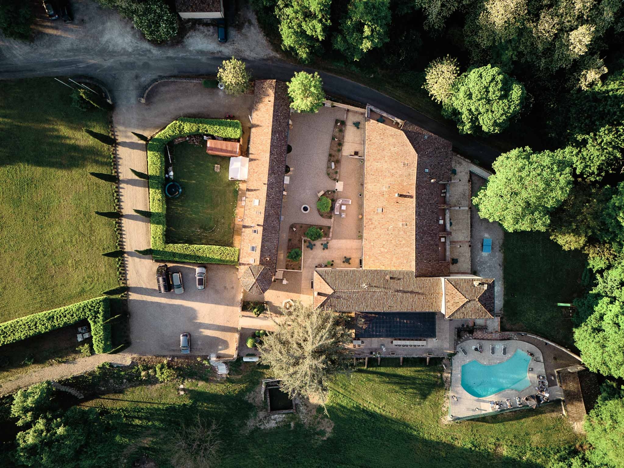 Aerial view of Château de Sanse, its pool and grounds