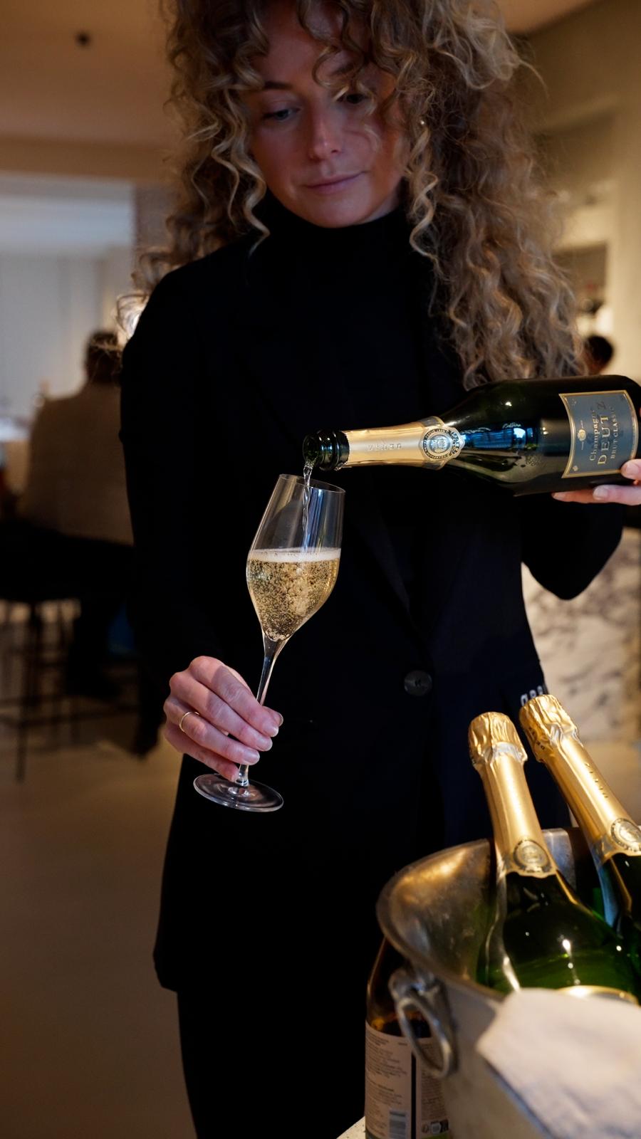 Champagne being poured by our front-of-house team