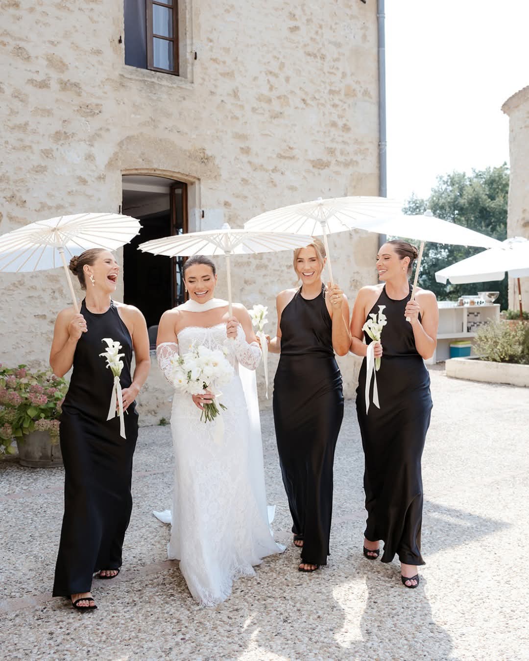 Bridal party walking together outside the château