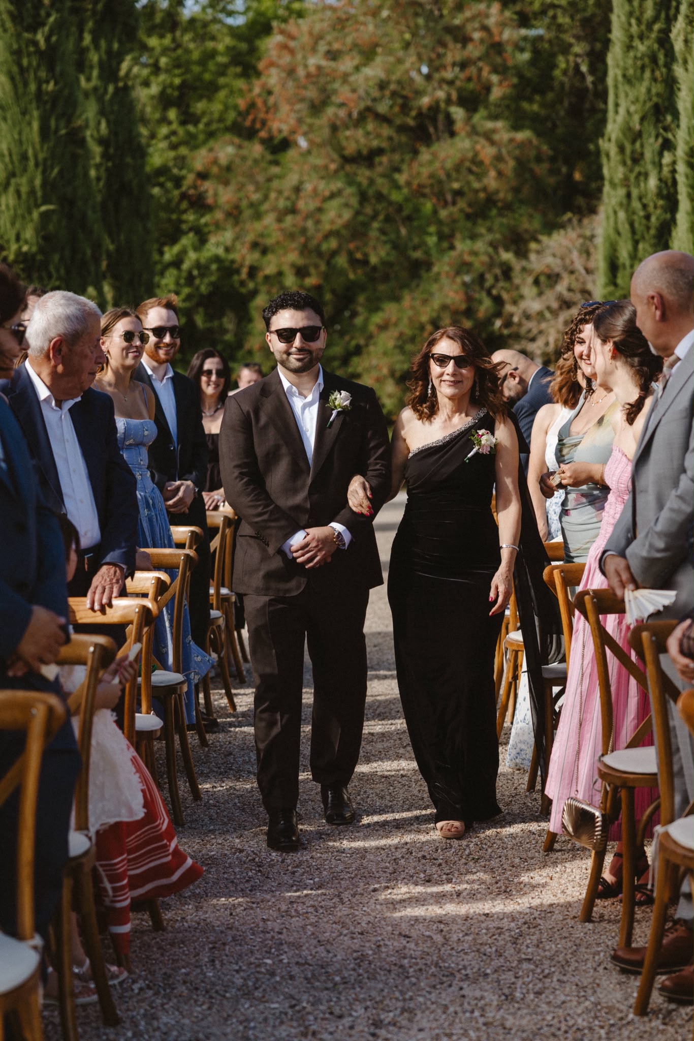 Groom and guests as the bridal procession passes