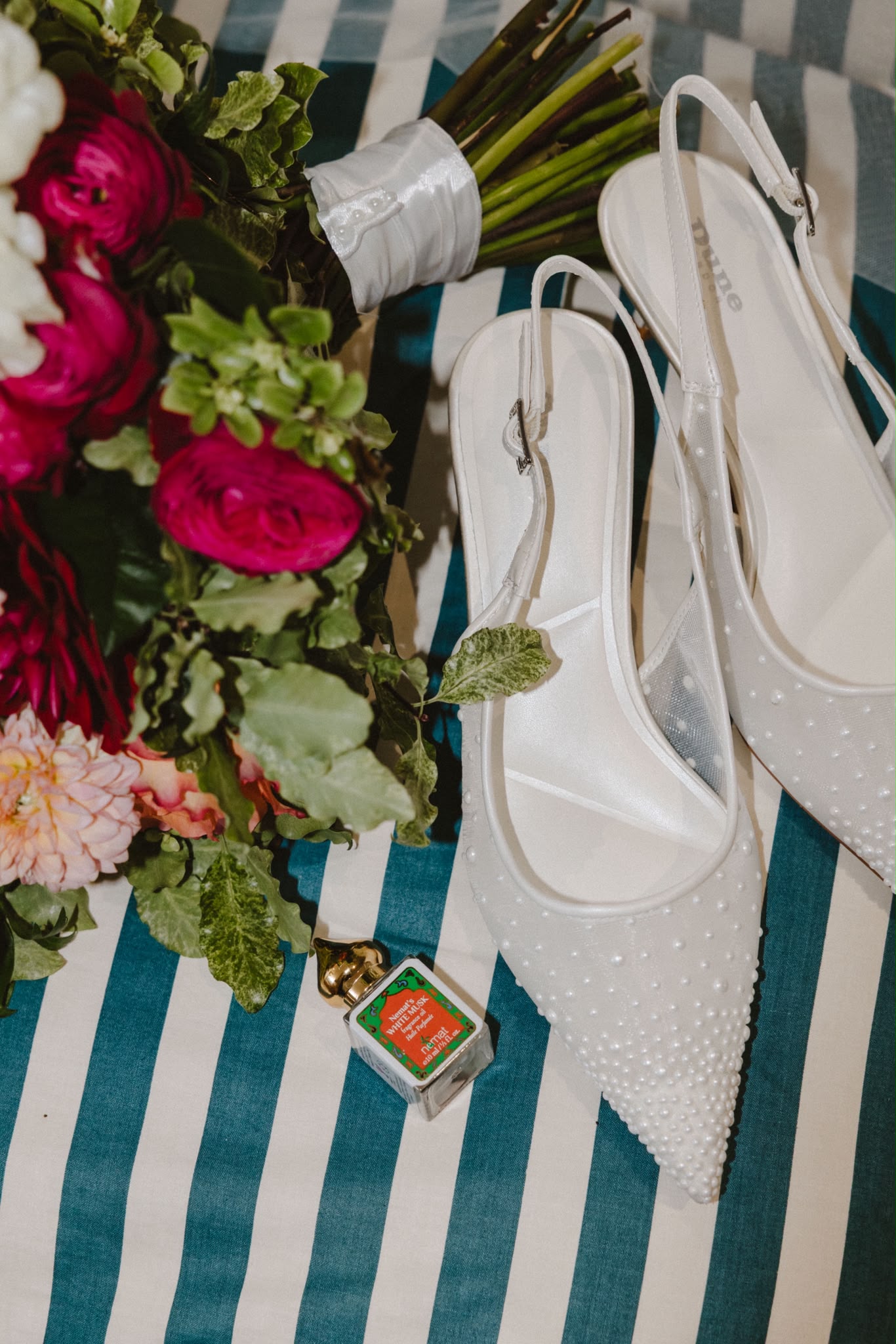 Wedding shoes and bouquet on a striped cloth