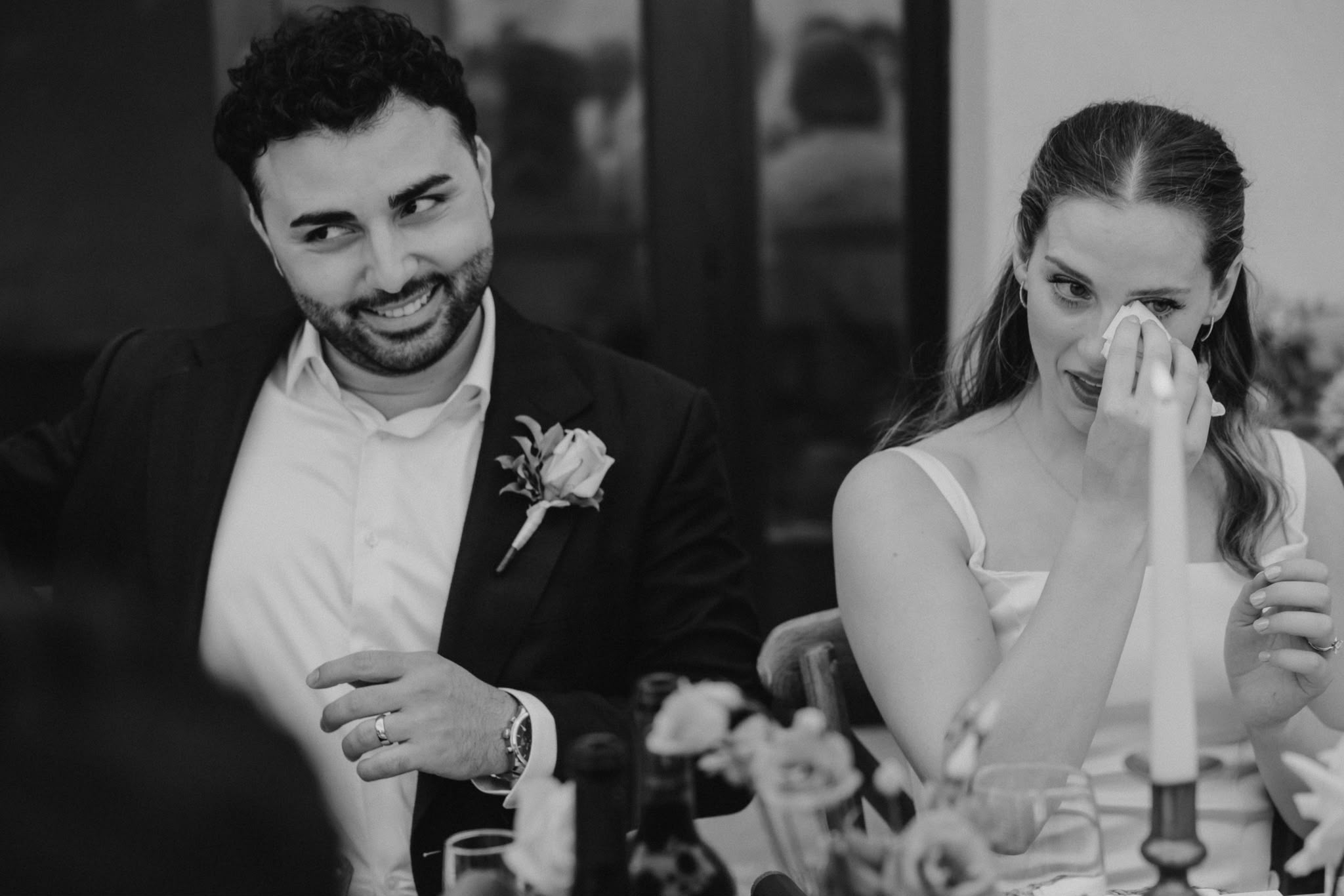 Couple sharing an emotional moment at dinner, in black and white