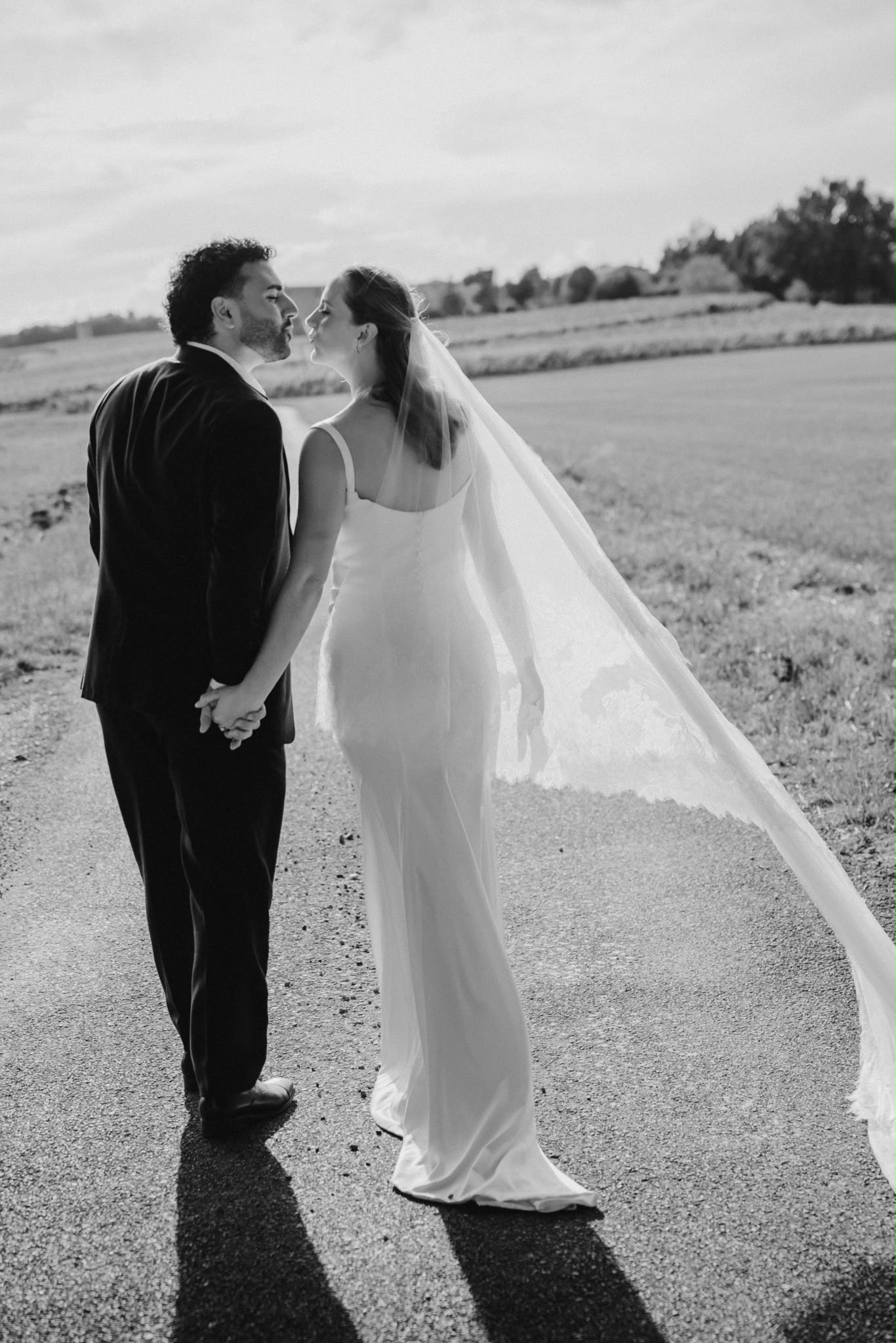 Couple kissing in the grounds, in black and white