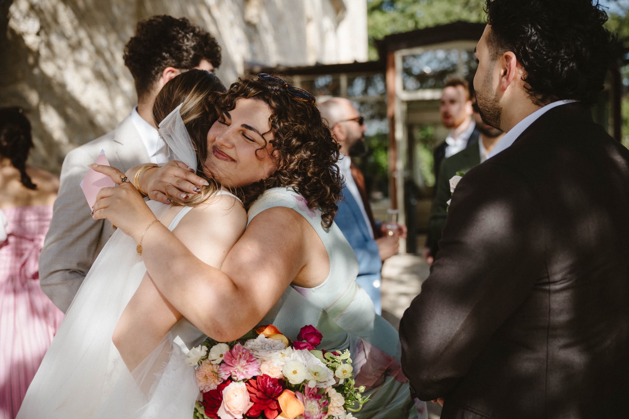 Bride embraced by loved ones