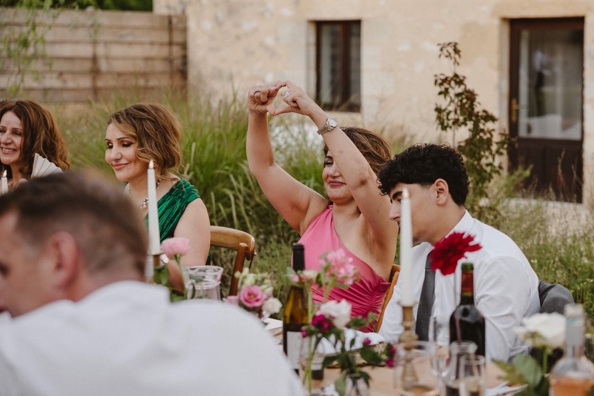 Guests laughing and toasting at the reception