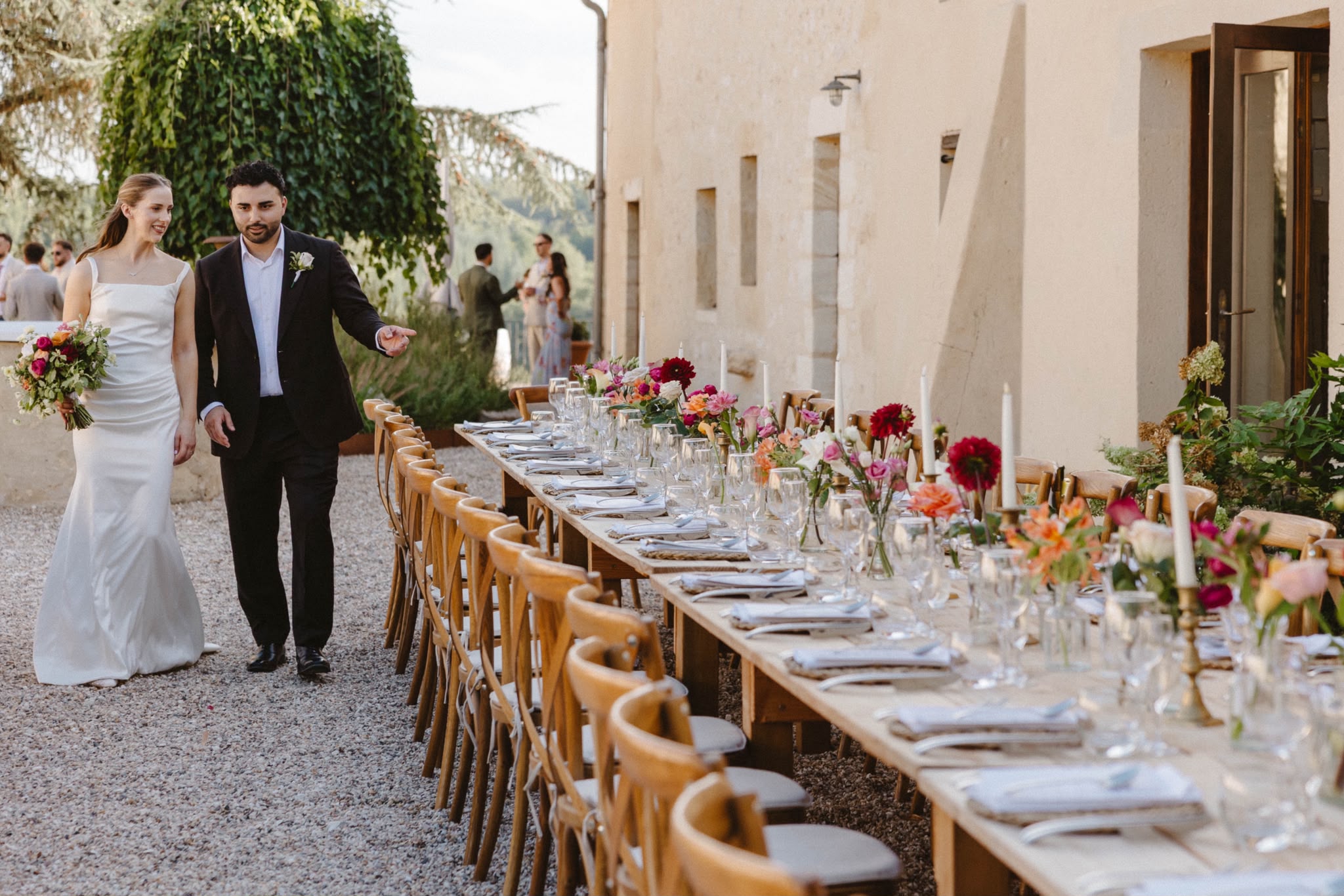 Long dining table beside the château as the couple arrive
