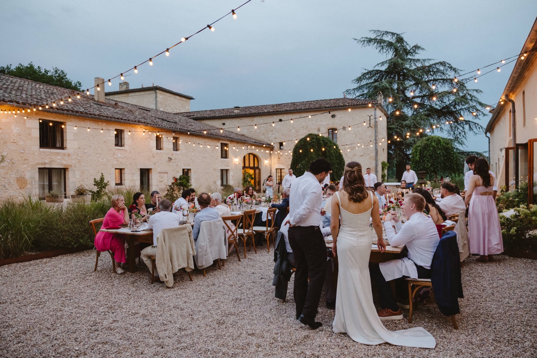 Wedding dinner tables in the courtyard at dusk