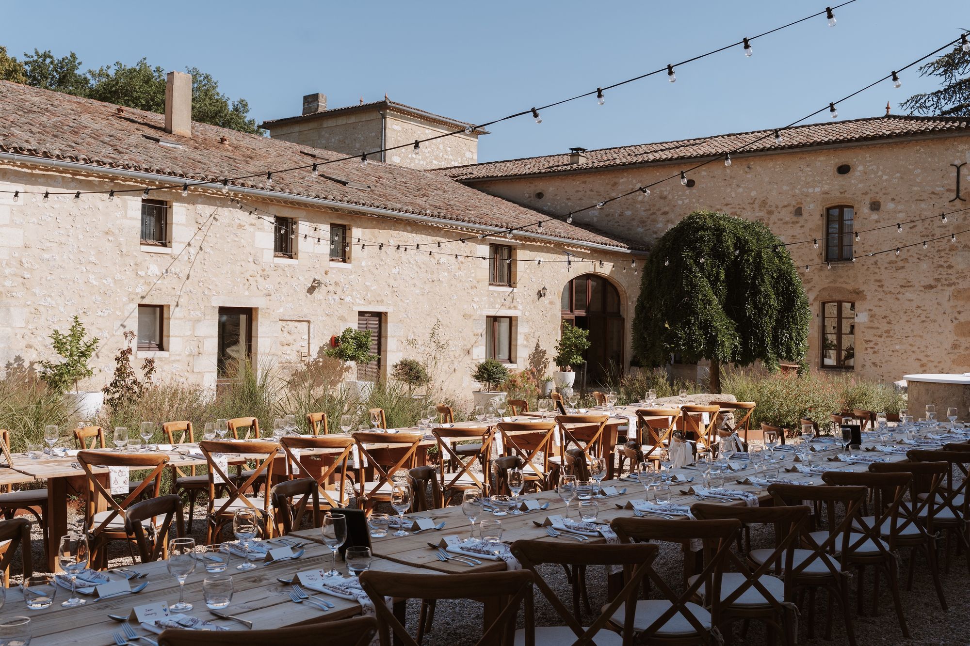 Wedding dinner in the courtyard under string lights